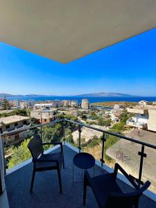 a balcony with chairs and a view of the city at Azzurre Premium Aparthotel in Sarandë