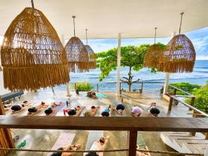 a group of people doing yoga in a pool at Laola Surf Residence in El Sunzal