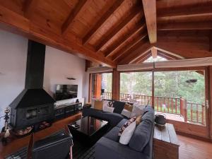 a living room with a couch and a fireplace at New listing! House with pool and garden, Urús in Urus