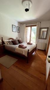 a bedroom with a large bed and a large window at New listing! House with pool and garden, Urús in Urus +21 photos