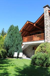 a house with a deck and two chairs in a yard at New listing! House with pool and garden, Urús in Urus