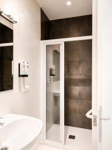 a bathroom with a white sink and a shower at Mas Ribas Hotel i Esdeveniments in Palamós +102 photos