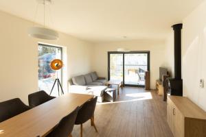 a living room with a table and a couch at Lipno Verde in Lipno nad Vltavou