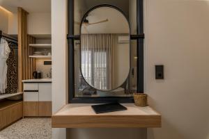 a mirror sitting on top of a counter in a bathroom at Six Doors in Pefkochori