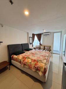 a bedroom with a large bed and a couch at The alt room by Vivo apartemen in Yogyakarta