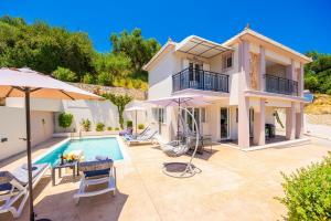 a villa with a swimming pool and a house at Villa Dimi in Tsilivi