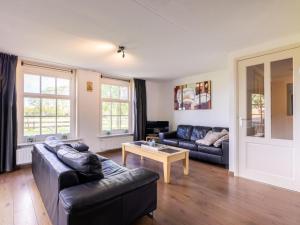a living room with a couch and a table at Limosa in Hippolytushoef