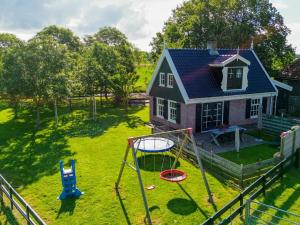 an aerial view of a house with a playground at Limosa in Hippolytushoef