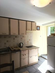 a kitchen with white cabinets and a counter top at Apartman sa suncem in Beli