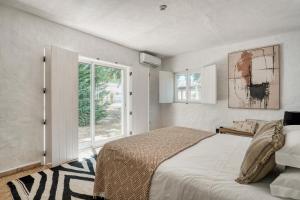 a bedroom with a large bed and a window at The Pink Stork Villa in Alcácer do Sal +18 photos