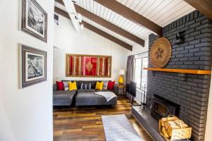 a living room with a couch and a fireplace at Mammoth's Best Location! 2BRLoft by Canyon Lodge in Mammoth Lakes