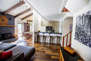 a living room with a couch and a kitchen at Mammoth's Best Location! 2BRLoft by Canyon Lodge in Mammoth Lakes