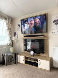 a living room with a flat screen tv at Coastal Escape Bude Resort in Bude