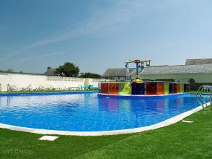 a large swimming pool with a colorful water slide at Coastal Escape Bude Resort in Bude