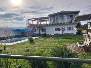 a villa with a swimming pool and a house at Mi casa de campo Tlayacapan in Tlayacapan