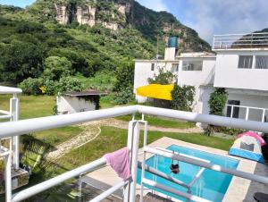 a view from the balcony of a house with a mountain at Mi casa de campo Tlayacapan in Tlayacapan