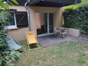 a wooden deck with a table and chairs on it at location Ax les Thermes in Ax-les-Thermes