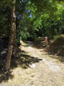 a sign on a dirt road next to a forest at location Ax les Thermes in Ax-les-Thermes