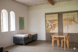a bedroom with a bed and a table and a table sidx sidx sidx at Gladeholm - Kivik - artist studio in Kivik