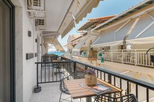 a balcony with tables and chairs on a building at Six Doors in Pefkochori