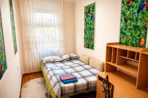 a small bedroom with a bed and a window at Large Appartment & Central Place in Tashkent