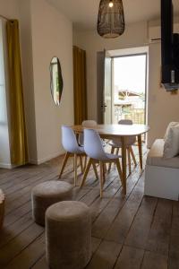 a living room with a dining room table and chairs at Gites Lisael et le 1808 proches Puy DuFou in Mauléon +52 photos
