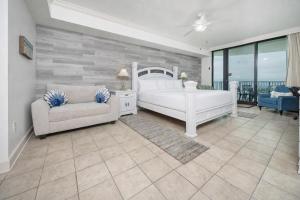a bedroom with a bed and a couch and a chair at Phoenix IX 1105 condo in Orange Beach +36 photos