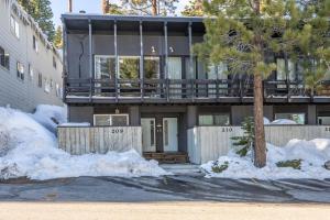a house with a tree in the snow at Pet Friendly 2B2B on Lake Basins Bike Path! in Mammoth Lakes