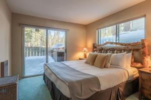 a bedroom with a bed and a large window at Pet Friendly 2B2B on Lake Basins Bike Path! in Mammoth Lakes
