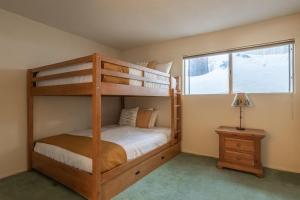 a bedroom with two bunk beds and a window at Pet Friendly 2B2B on Lake Basins Bike Path! in Mammoth Lakes +30 photos