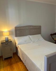 a bedroom with a bed and a lamp on a night stand at Cà Dal Vindu in Biella