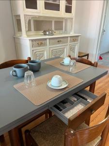 a dining room table with two plates and bowls on it at Cà Dal Vindu in Biella