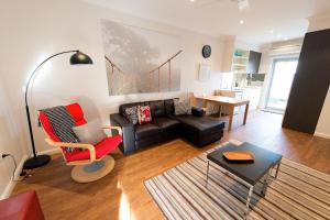a living room with a couch and a table at Apartments by Townhouse in Wagga Wagga