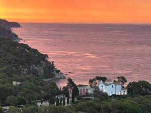 a house on a hill next to the ocean at Villa La Gavina Sea View Pool and Beaches in Blanes