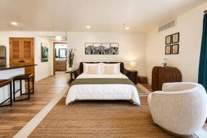 a large bedroom with a bed and a chair at Edelweiss Escape in Leavenworth +52 photos