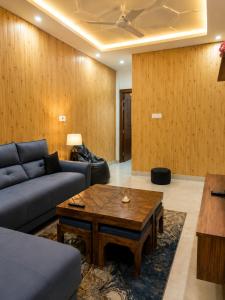 a living room with a couch and a coffee table at The Elite Luxury Suite in Dehradun +1 photo