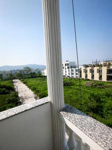 a window with a view of a street and buildings at The Elite Luxury Suite in Dehradun