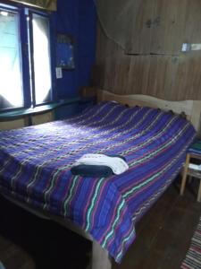 a bed in a room with a blanket on it at Dorm in Hopkins