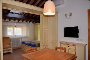 a room with a dining table and a bedroom at Il Cantinone A due passi dal mare in San Vincenzo