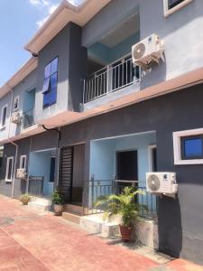a building with two air conditioners on the side of it at House 22 Apartments in Kubwa