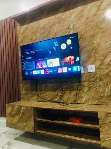 a flat screen tv sitting on top of a entertainment center at House 22 Apartments in Kubwa