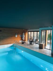 a swimming pool in a house with a living room at La Maison d'Augustin in Mont-de-Marsan