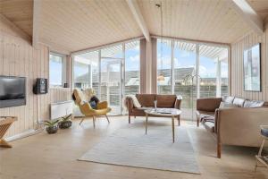a living room with a couch and chairs and a tv at 30101-Malling-Noddevaenget-5-A in Malling