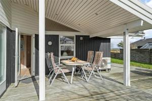 a patio with a table and chairs on a deck at 30101-Malling-Noddevaenget-5-A in Malling