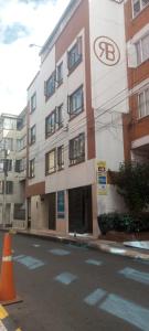 a building on a street with an orange cone in front of it at Hotel Bonaire Un Estilo Difrente in Bogotá