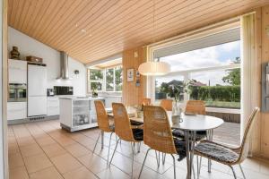 a kitchen and dining room with a table and chairs at C11333-Tarm-Laksestien-6 in Tarm