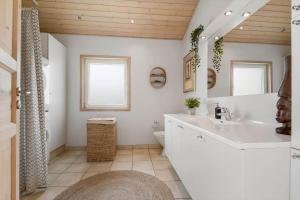 a white bathroom with a sink and a toilet at C11333-Tarm-Laksestien-6 in Tarm