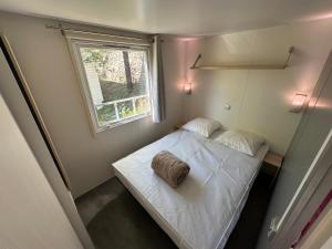a small bedroom with a bed and a window at l echo du canigou in Sahorre