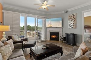 a living room with a couch and a fireplace at Sanctuary at Redfish 2115 by Newman-Dailey in Santa Rosa Beach