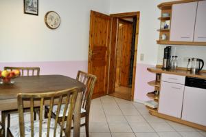 a kitchen and dining room with a table and chairs at Cafe-Kuckuck in Salzwedel +9 photos